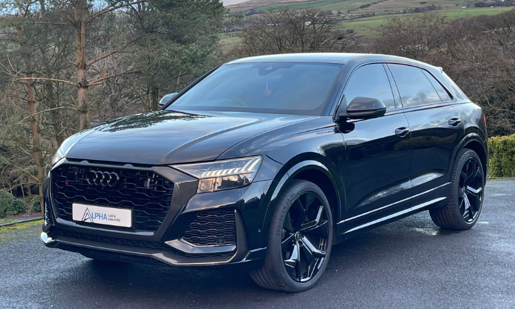 Modern black Audi SUV countryside cover